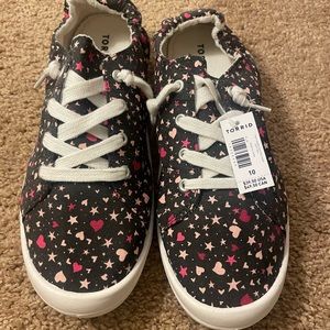 Brand new w/ tags, Torrid slip-on sneakers. Black with hearts and stars Size 10
